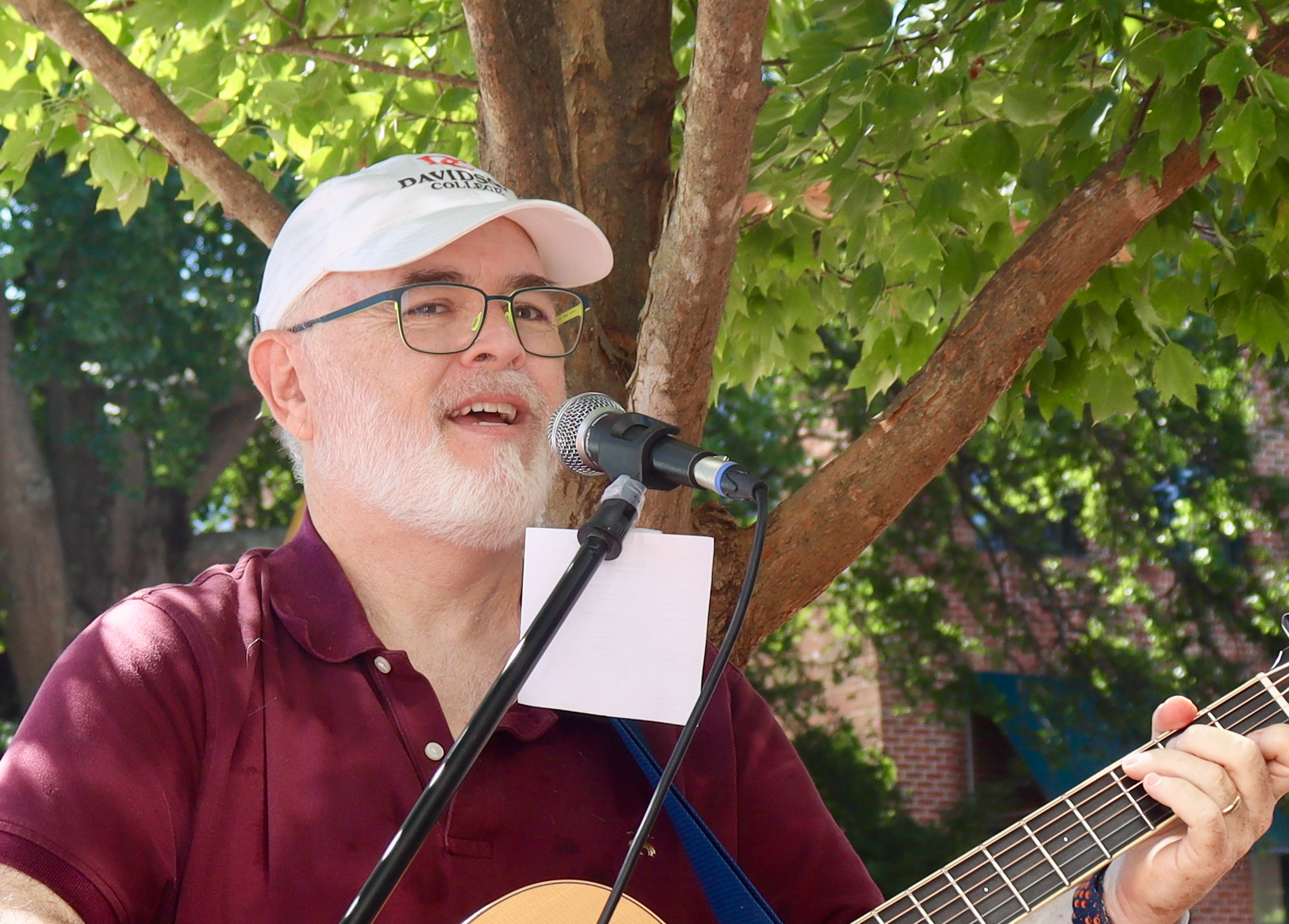 Bill Barnett performing outdoors with acoustic guitar
